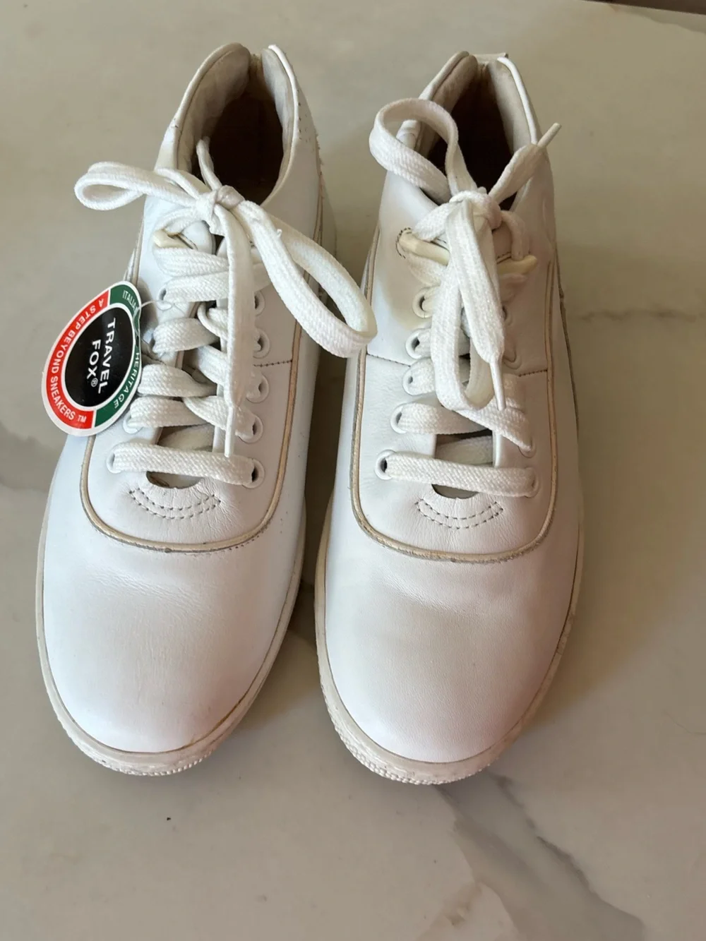 Travel Fox white sneakers size 7 back tab has a tear